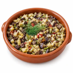 Frito mallorquín de Can Pep Gourmet, presentación en cazuela sobre fondo blanco